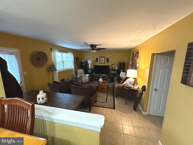 tiled dining space with ceiling fan