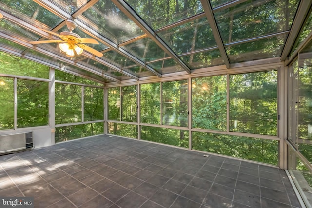 unfurnished sunroom with lofted ceiling, ceiling fan, and a wall mounted air conditioner