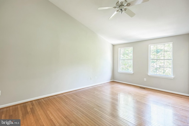 spare room with lofted ceiling, light hardwood / wood-style flooring, and ceiling fan