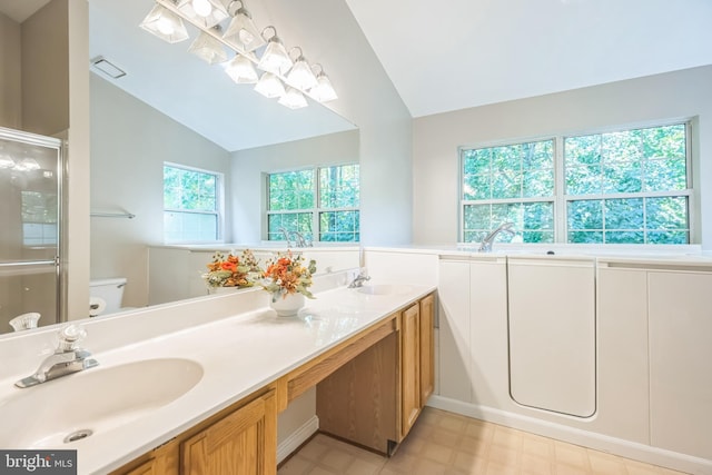 bathroom featuring a shower with door, vanity, vaulted ceiling, and toilet