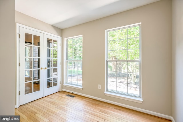 doorway featuring light wood-type flooring and french doors