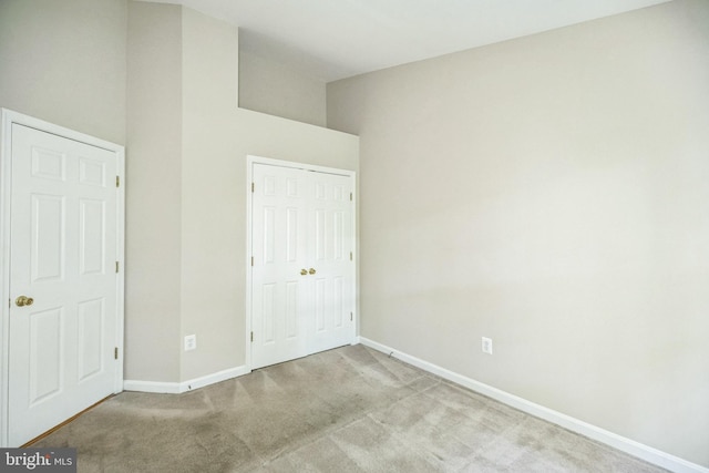 unfurnished bedroom featuring light carpet