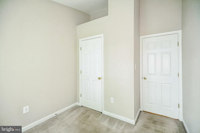 unfurnished bedroom featuring light colored carpet