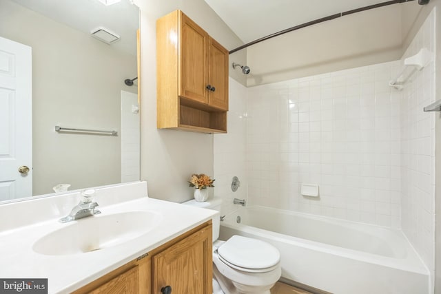 full bathroom with vanity, toilet, and tiled shower / bath combo