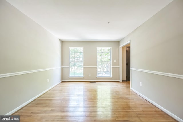 unfurnished room with light wood-type flooring