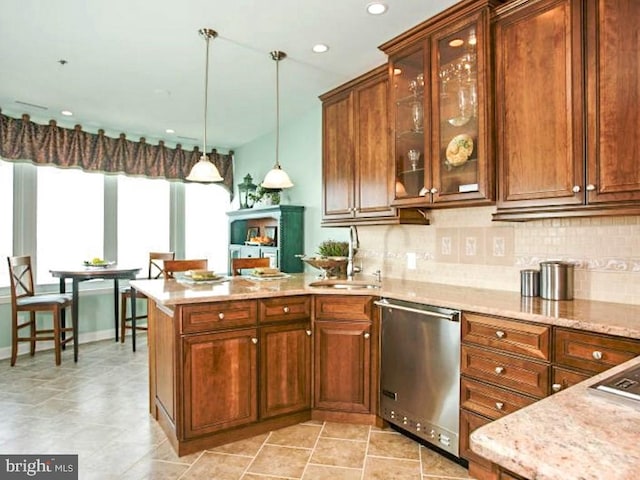 kitchen featuring backsplash, light tile floors, sink, dishwasher, and hanging light fixtures