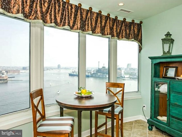 tiled dining space with a water view