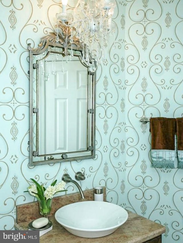 bathroom with a chandelier and vanity