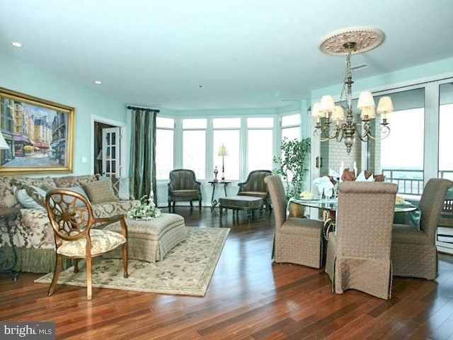 dining space featuring an inviting chandelier and dark wood-type flooring