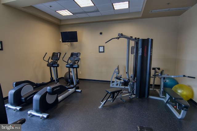 workout area featuring a paneled ceiling