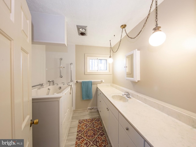 full bathroom with vanity and a textured ceiling