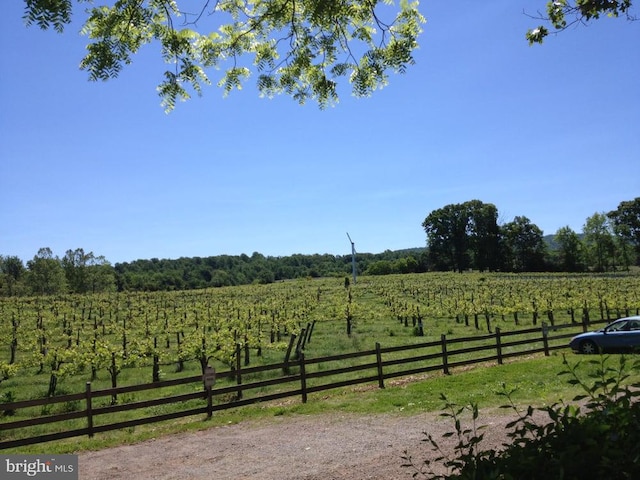 view of yard featuring a rural view and fence