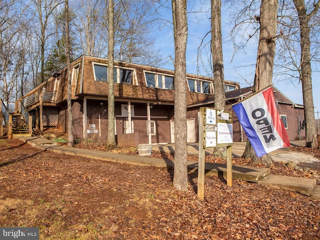 rear view of house featuring stairway