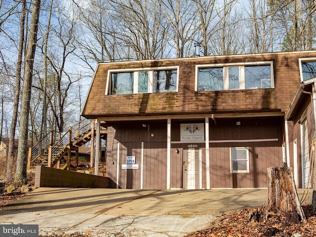 view of front of property featuring stairway