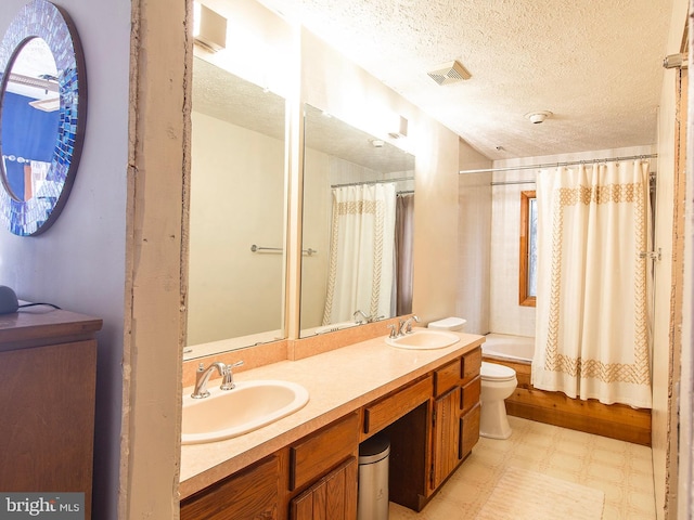 full bathroom with vanity, a textured ceiling, toilet, and shower / bathtub combination with curtain