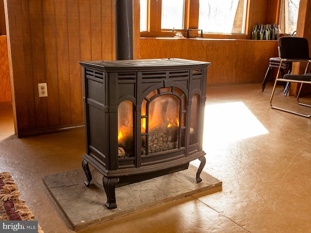 interior details with wood walls and a wood stove