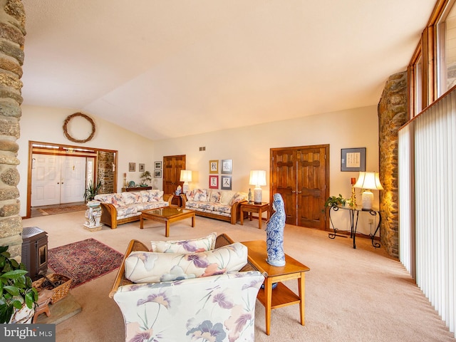 bedroom with vaulted ceiling, a wood stove, and light colored carpet