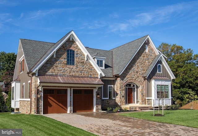 view of front of house with a front yard and a garage