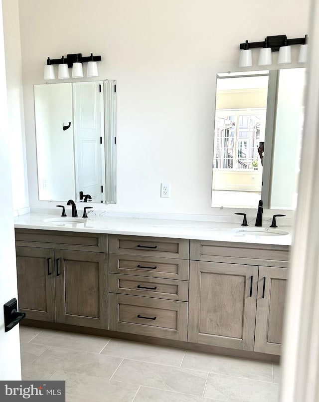 bathroom with double sink vanity and tile floors