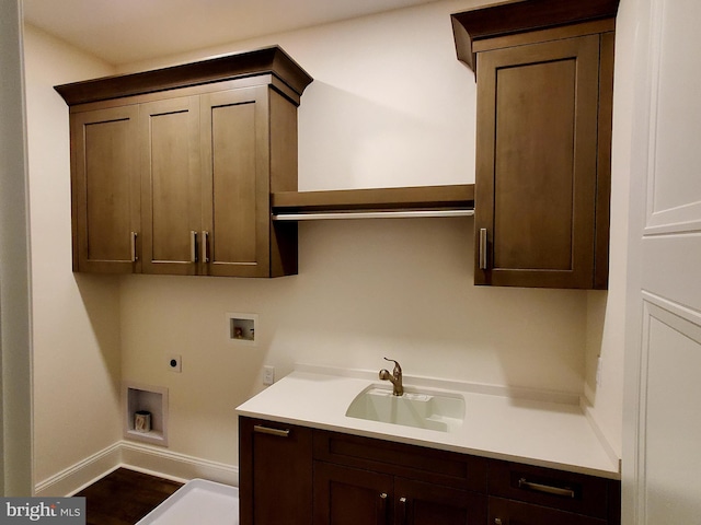 clothes washing area with hookup for an electric dryer, sink, cabinets, washer hookup, and dark hardwood / wood-style floors