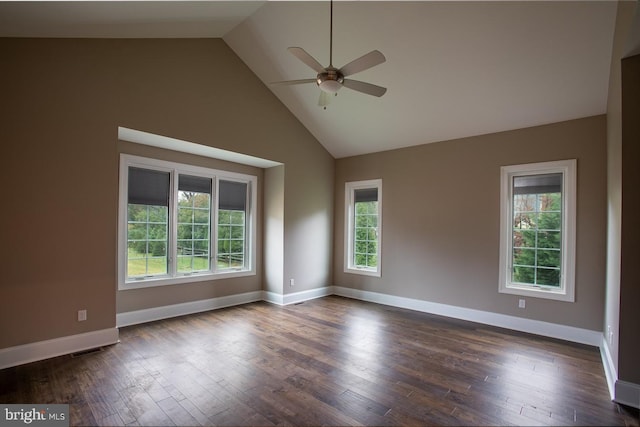 empty room featuring ceiling fan, dark hardwood / wood-style floors, high vaulted ceiling, and a healthy amount of sunlight