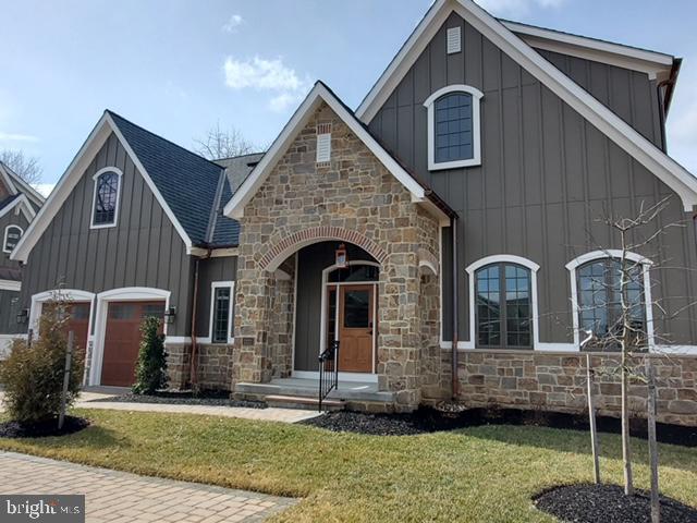 view of front of property with a front lawn and a garage