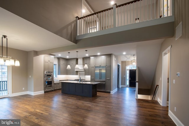 kitchen featuring dark hardwood / wood-style floors, decorative light fixtures, gray cabinetry, and custom exhaust hood