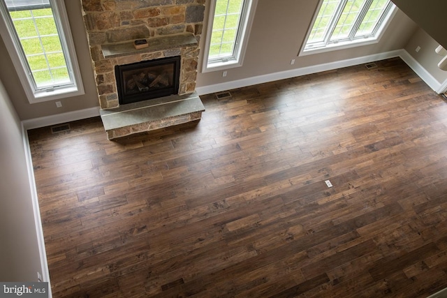 unfurnished living room featuring dark hardwood / wood-style floors and a fireplace