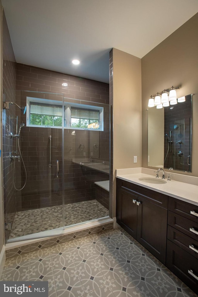 bathroom with vanity, tile floors, and a shower with door