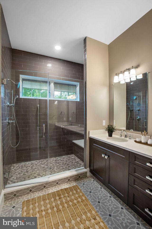 bathroom featuring walk in shower, tile flooring, and vanity