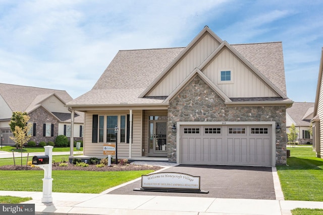 view of front of property with a front yard and a garage