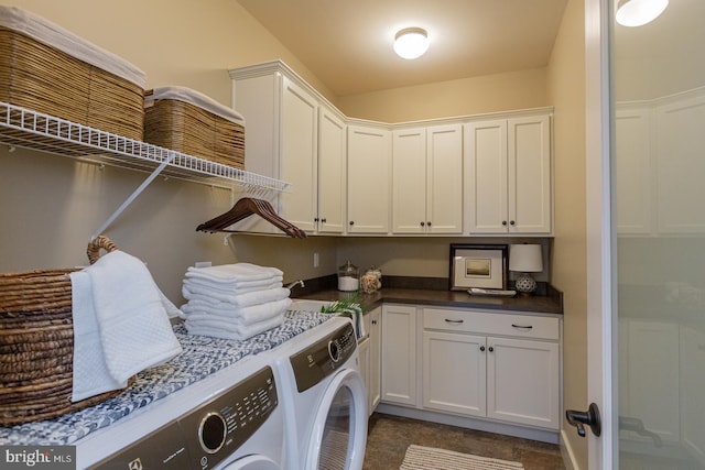 laundry area featuring washing machine and dryer, cabinets, and dark colored carpet