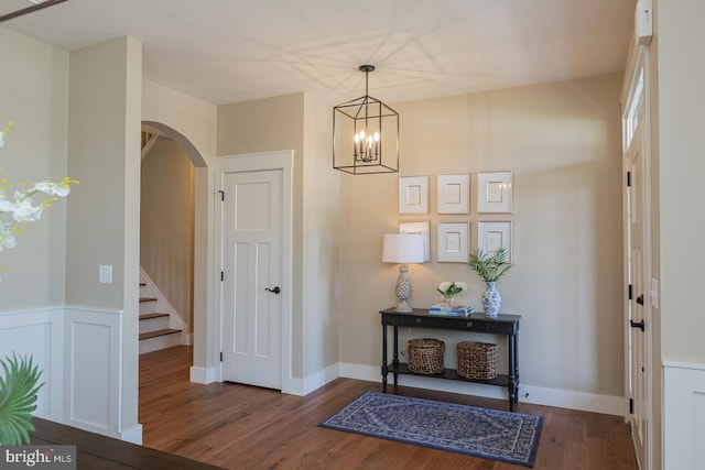 entryway featuring dark hardwood / wood-style floors and a notable chandelier