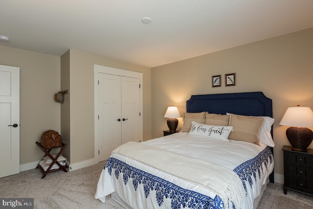 bedroom with a closet and light colored carpet