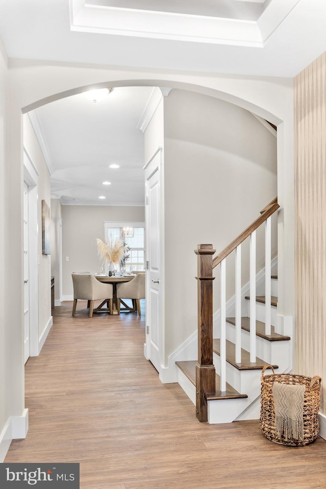 corridor featuring light hardwood / wood-style floors and ornamental molding