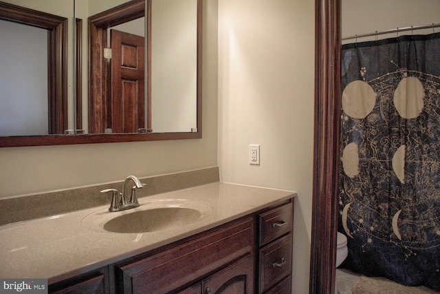 bathroom featuring toilet and large vanity