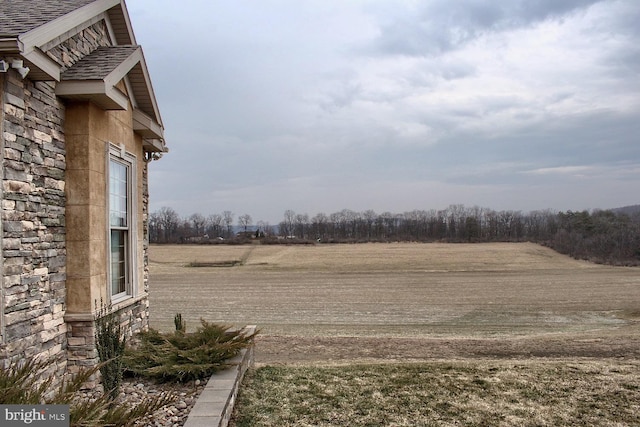 view of yard with a rural view