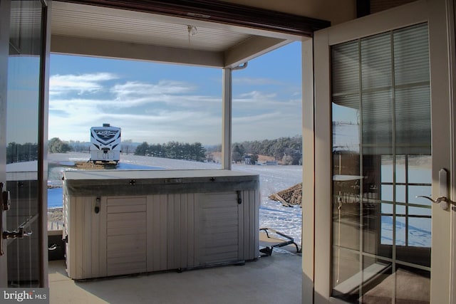 snow covered patio featuring a hot tub