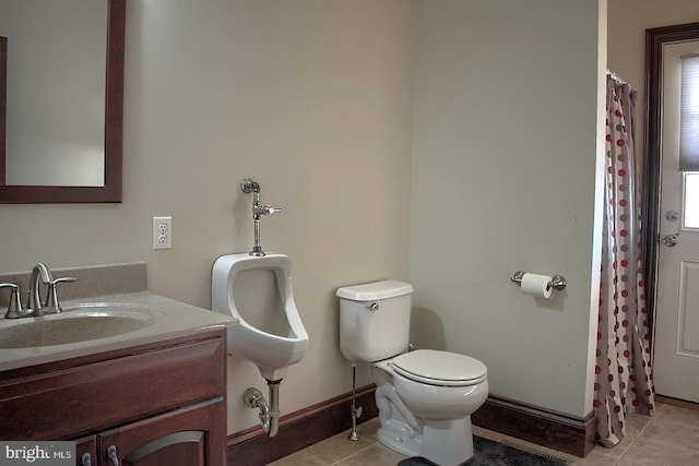 bathroom with vanity with extensive cabinet space, toilet, and tile flooring