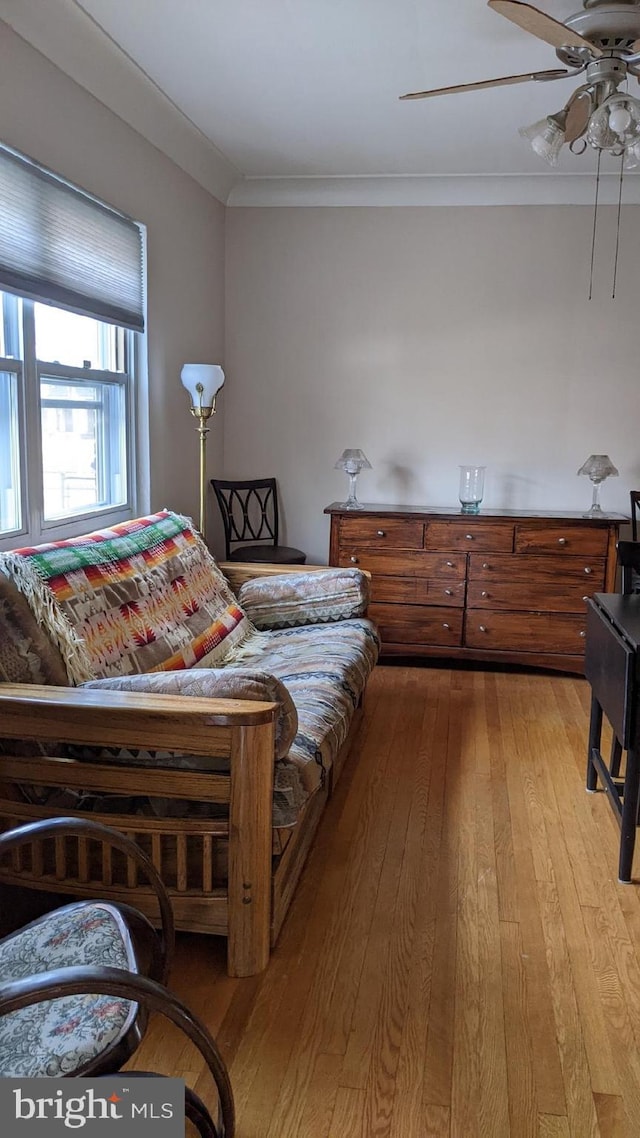 bedroom featuring ceiling fan, crown molding, and light hardwood / wood-style floors