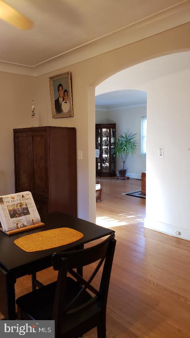 dining space with light hardwood / wood-style floors and ornamental molding