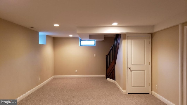 basement featuring light colored carpet