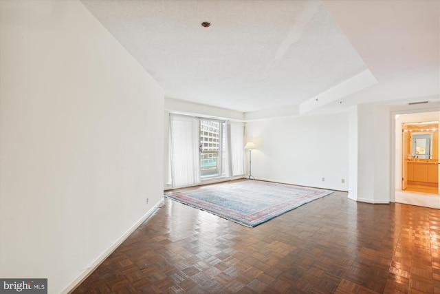 empty room with dark parquet floors