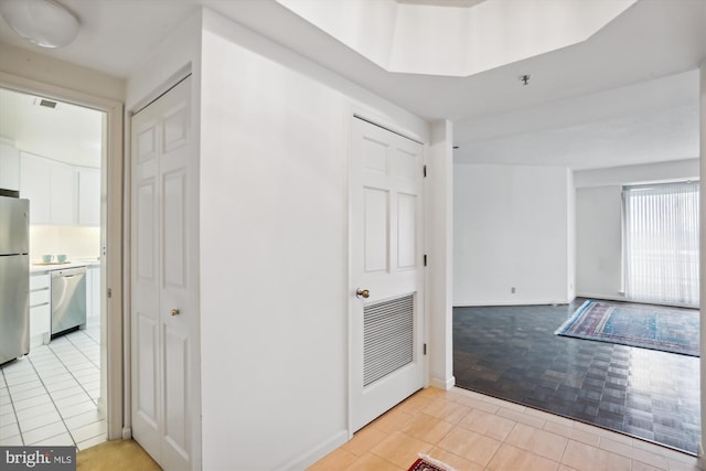 hallway with light tile floors