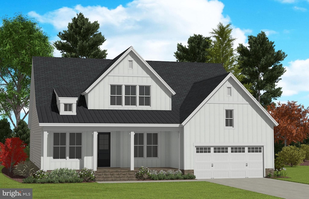 modern farmhouse featuring a front yard, covered porch, and a garage