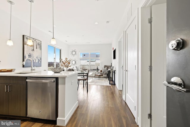 kitchen featuring stainless steel dishwasher, pendant lighting, and dark wood-type flooring