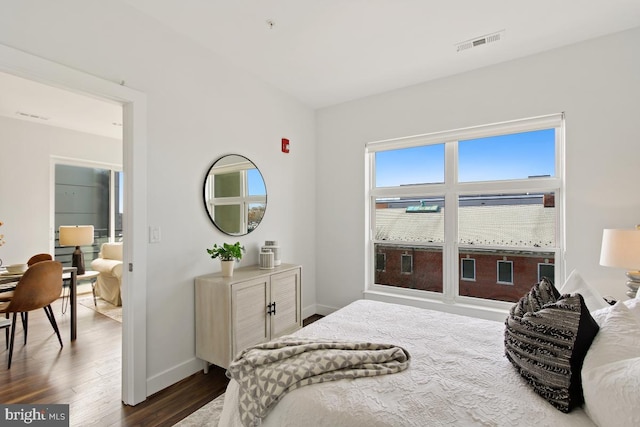 bedroom with dark wood-type flooring