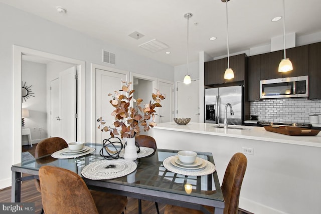 dining room featuring sink and hardwood / wood-style flooring