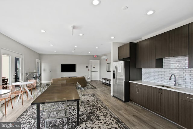 kitchen with tasteful backsplash, dark brown cabinets, stainless steel refrigerator with ice dispenser, hardwood / wood-style flooring, and french doors