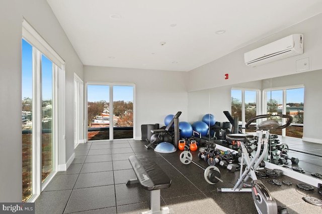 gym featuring a wall mounted AC and a healthy amount of sunlight